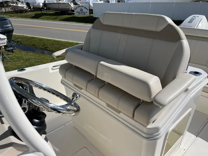 Slide: The Image of 2025 Boston Whaler 280 Dauntless helm seat and steering wheel, showcasing luxury marine design. - 18