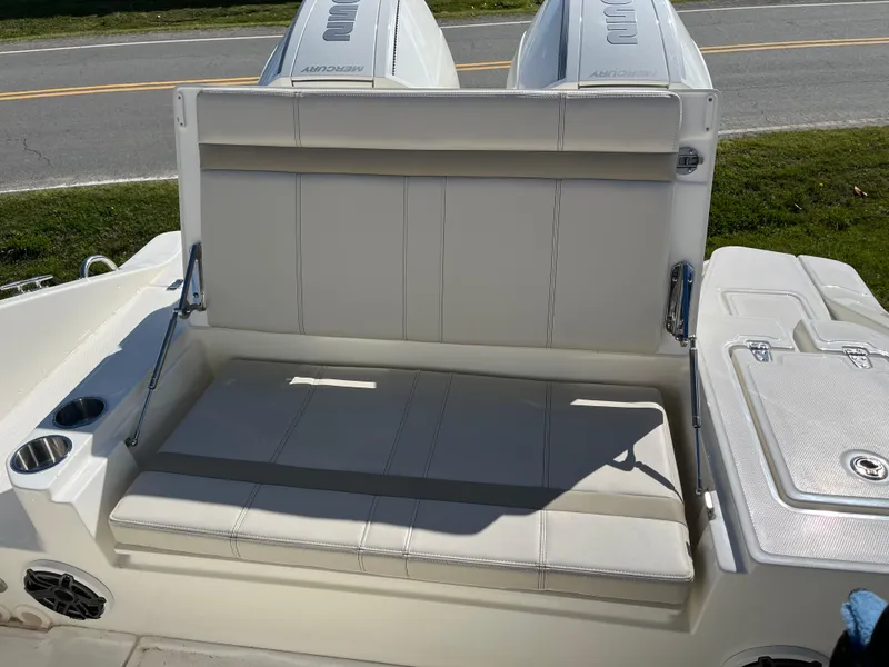 Slide: The Image of 2025 Boston Whaler 280 Dauntless boat seating area with dual engines in background. - 20