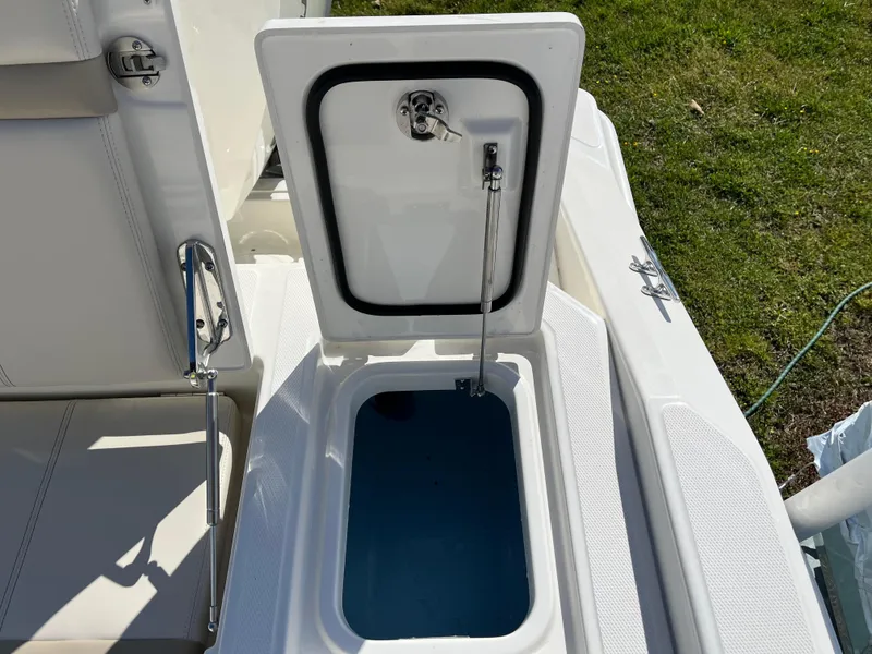 Slide: The Image of Open storage compartment on 2025 Boston Whaler 280 Dauntless boat, showing interior details. - 21