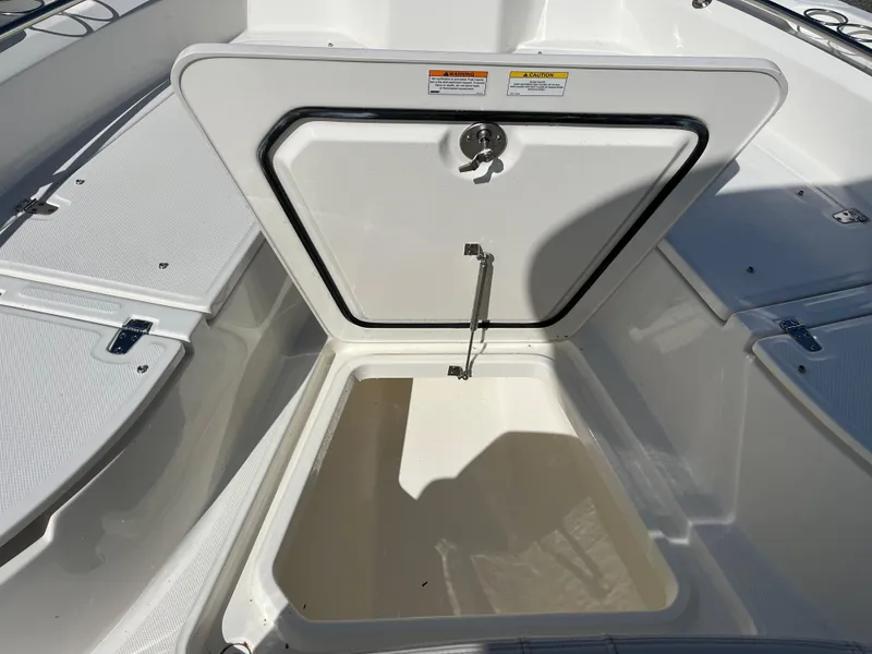 Slide: The Image of 2025 Boston Whaler 280 Dauntless storage compartment open, showcasing spacious interior. - 26