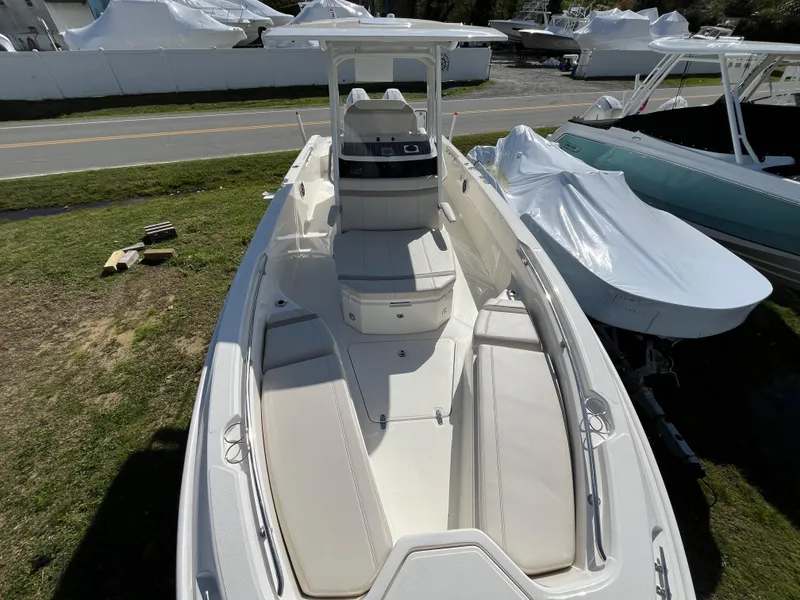 Slide: The Image of 2025 Boston Whaler 280 Dauntless boat, top view, parked on grass. - 3