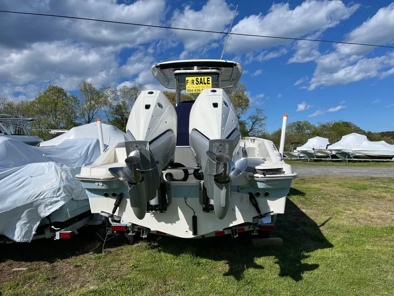 Slide: The Image of 2025 Boston Whaler 280 Dauntless boat for sale, dual engines, parked on grass. - 30