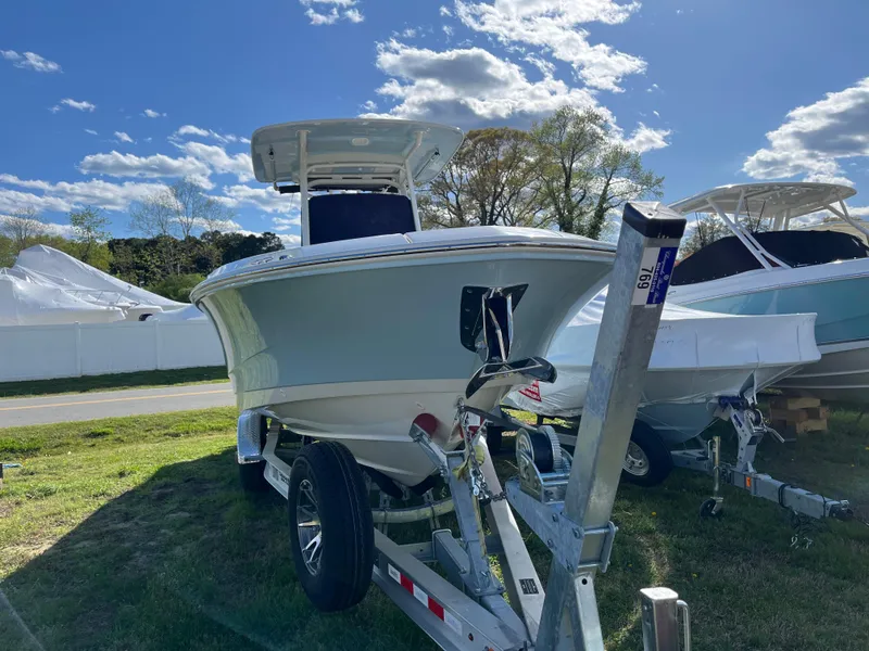 Slide: The Image of 2025 Boston Whaler 280 Dauntless boat on trailer under a sunny sky. - 33