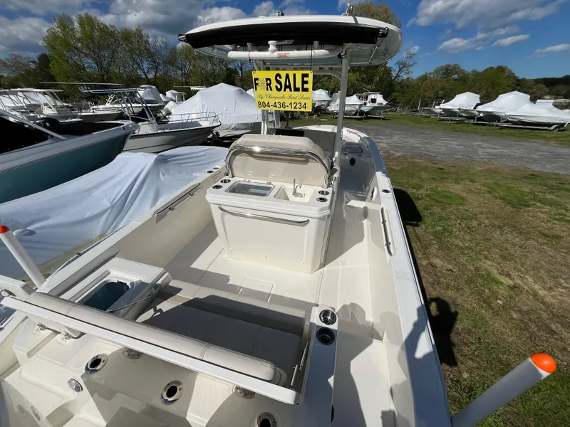 Slide: The Image of 2025 Boston Whaler 280 Dauntless boat for sale, docked outdoors under a clear sky. - 4