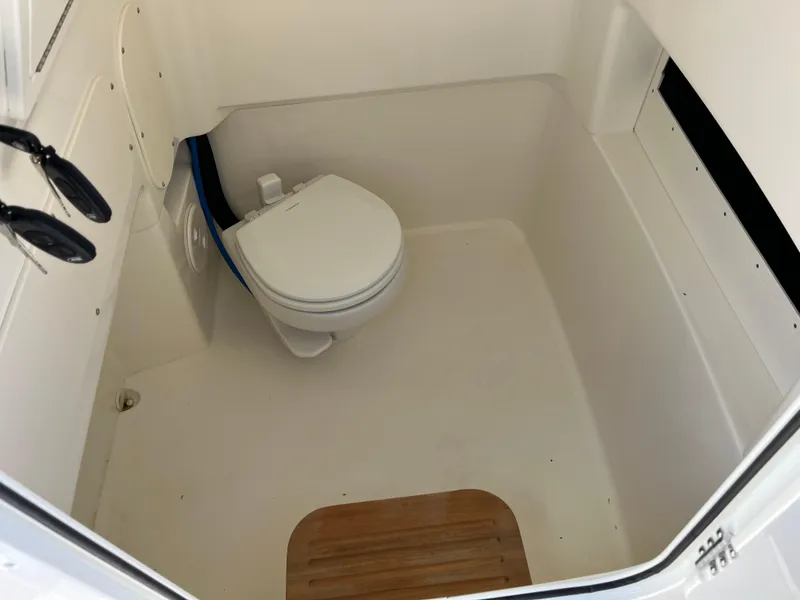 Slide: The Image of 2025 Boston Whaler 280 Dauntless boat interior with compact marine toilet. - 6
