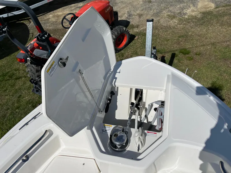 Slide: The Image of Open storage compartment on 2025 Boston Whaler 280 Dauntless boat, with visible anchor equipment. - 8
