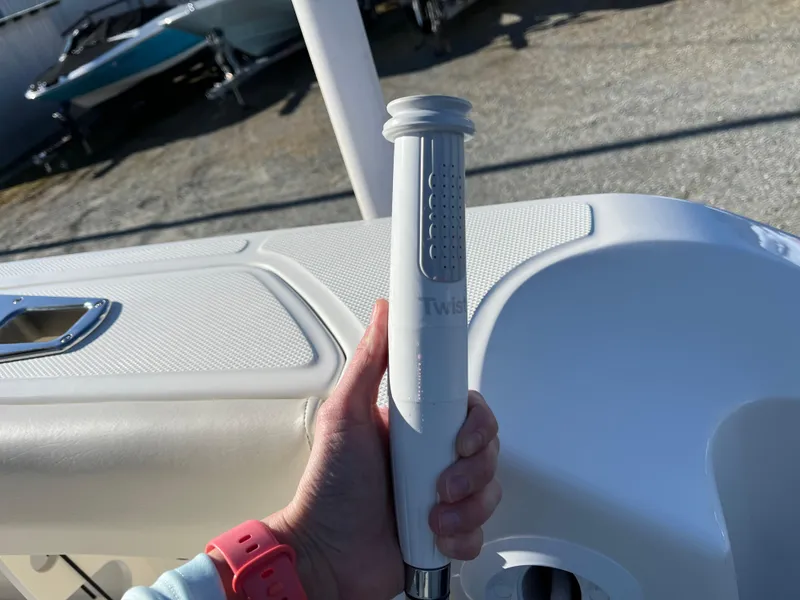 Slide: The Image of Hand holding a handle on a 2025 Boston Whaler 250 Outrage boat deck. - 11