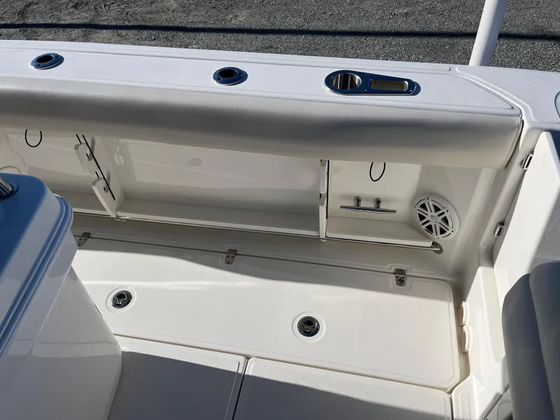 Slide: The Image of 2025 Boston Whaler 250 Outrage boat interior with storage compartments and speaker. - 12