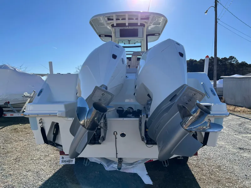 Slide: The Image of 2025 Boston Whaler 250 Outrage boat with dual outboard engines, rear view. - 2