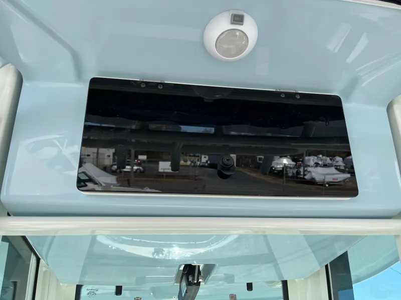 Slide: The Image of 2025 Boston Whaler 250 Outrage boat interior with speaker and reflective panel. - 20