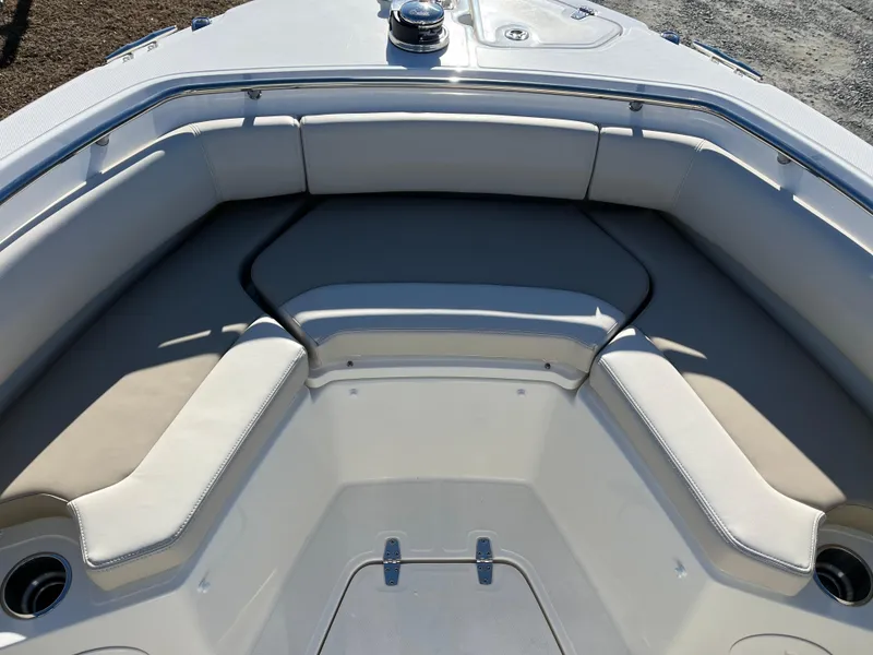Slide: The Image of 2025 Boston Whaler 250 Outrage boat interior with cushioned seating and cup holders. - 23