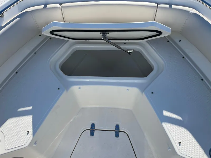 Slide: The Image of 2025 Boston Whaler 250 Outrage boat storage compartment, open hatch, spacious interior. - 26
