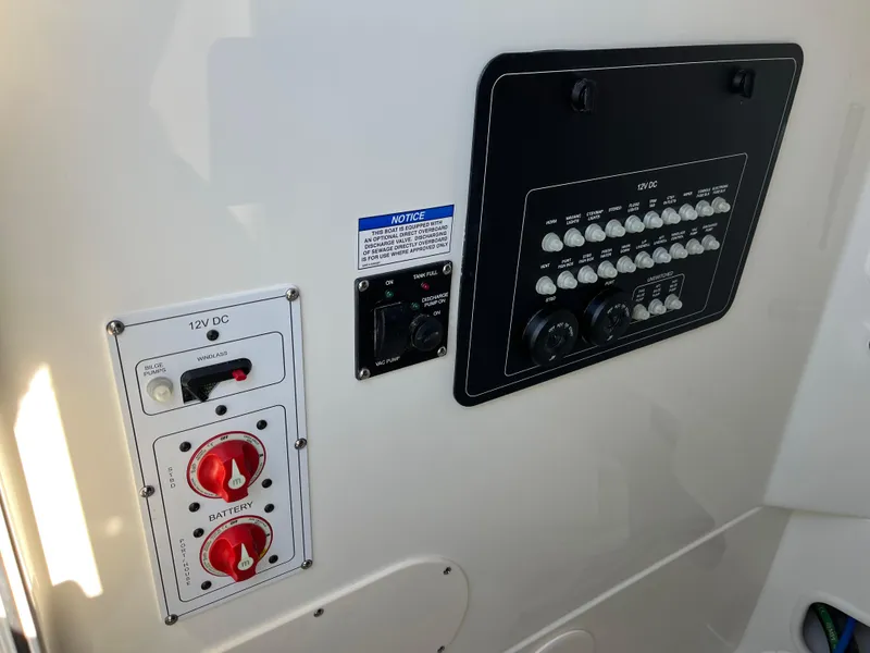 Slide: The Image of Control panel of 2025 Boston Whaler 250 Outrage boat, featuring switches and dials. - 28