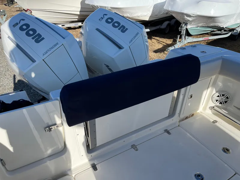 Slide: The Image of 2025 Boston Whaler 250 Outrage boat with dual outboard engines and cushioned seating. - 29