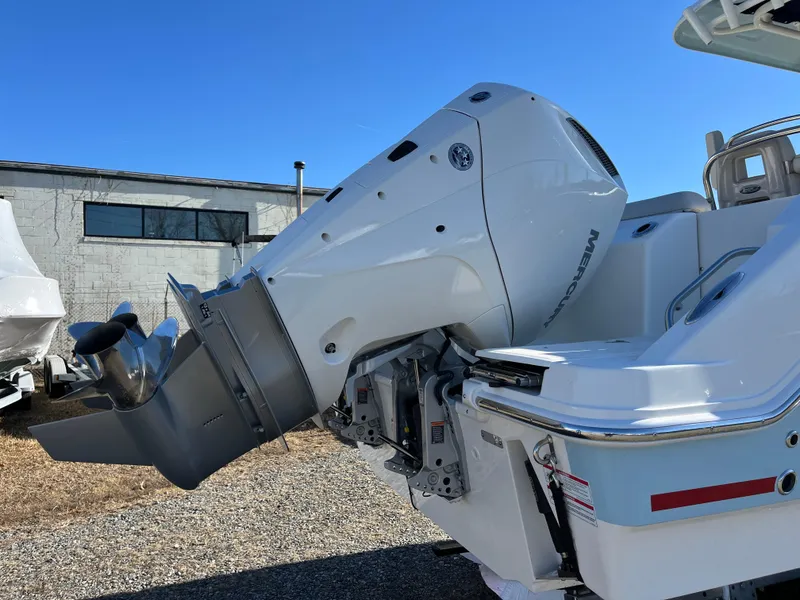 Slide: The Image of 2025 Boston Whaler 250 Outrage boat with powerful outboard motor, parked outdoors. - 30