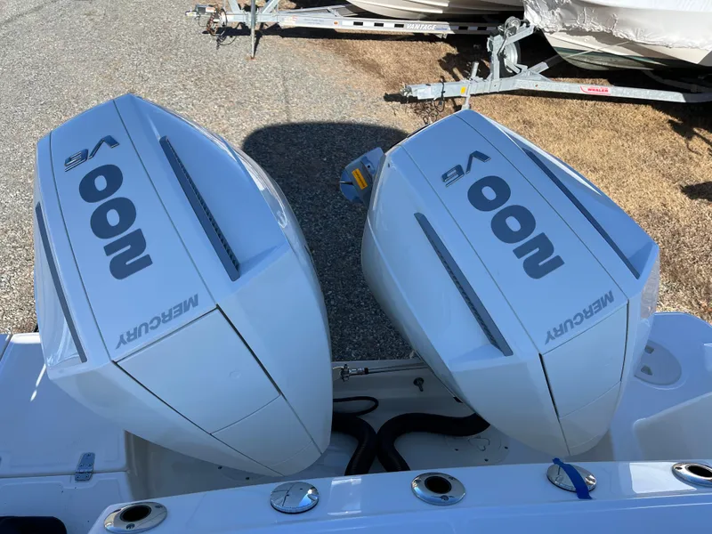 Slide: The Image of Twin Mercury V8 engines on a 2025 Boston Whaler 250 Outrage boat. - 32