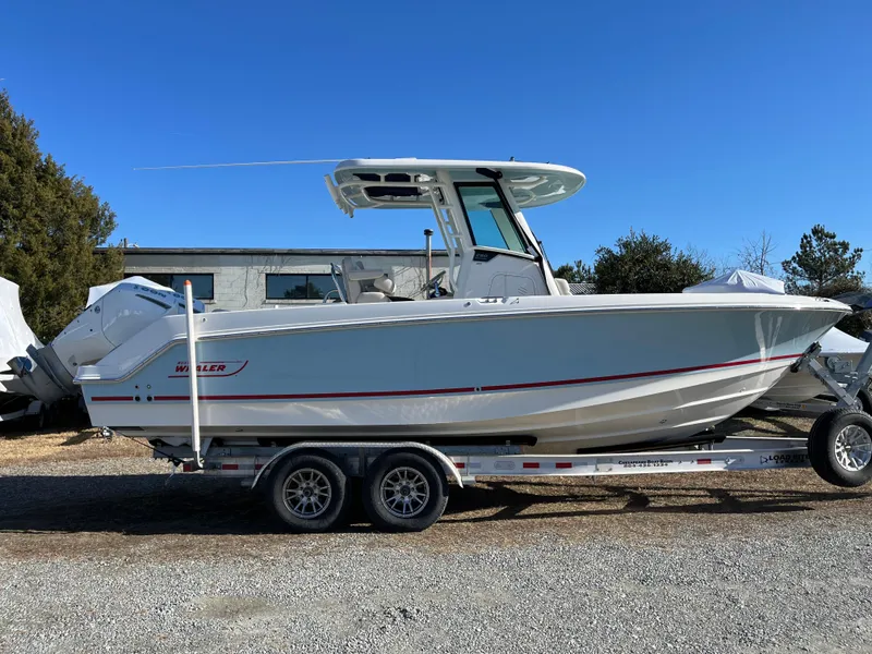 Slide: The Image of 2025 Boston Whaler 250 Outrage boat on trailer, side view, outdoors. - 33