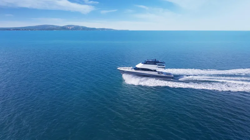 Slide: The Image of 2026 Maritimo M600 yacht cruising on open blue sea under clear sky. - 3