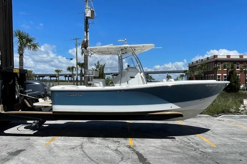 Slide: The Image of 2017 Regulator R23 boat on a lift in a sunny marina. - 1