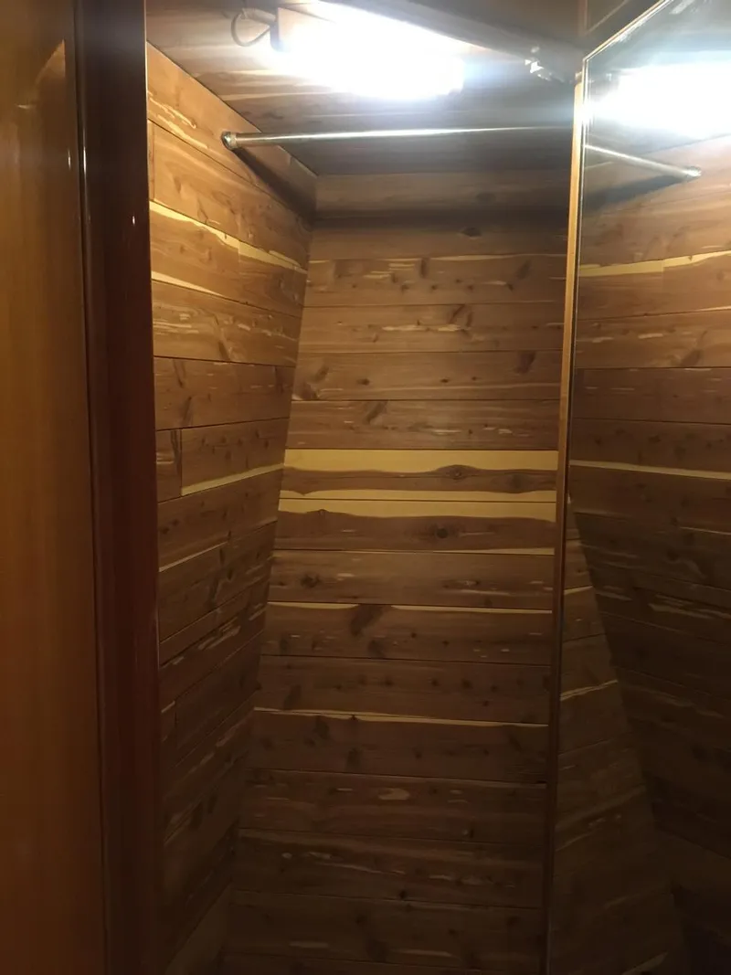 Slide: The Image of Wood-paneled closet interior on a 2004 McKinna 58 yacht. - 11