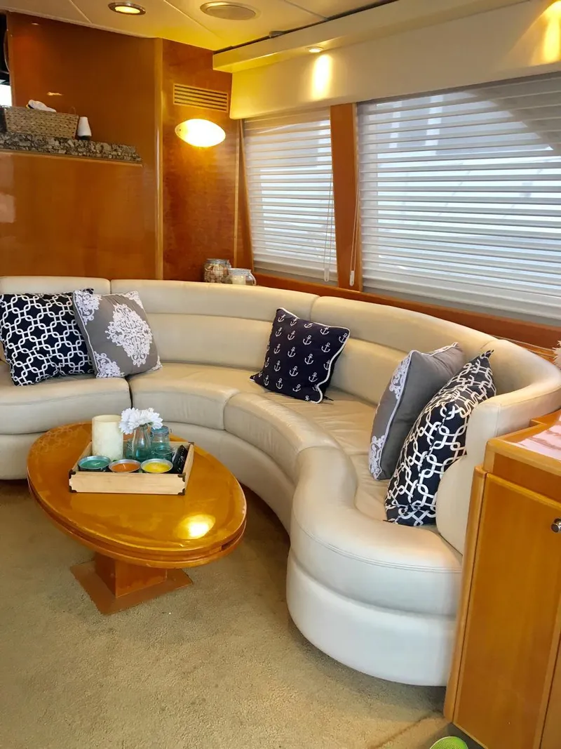 Slide: The Image of Luxurious interior of a 2004 McKinna 58 yacht with elegant seating and decorative pillows. - 2
