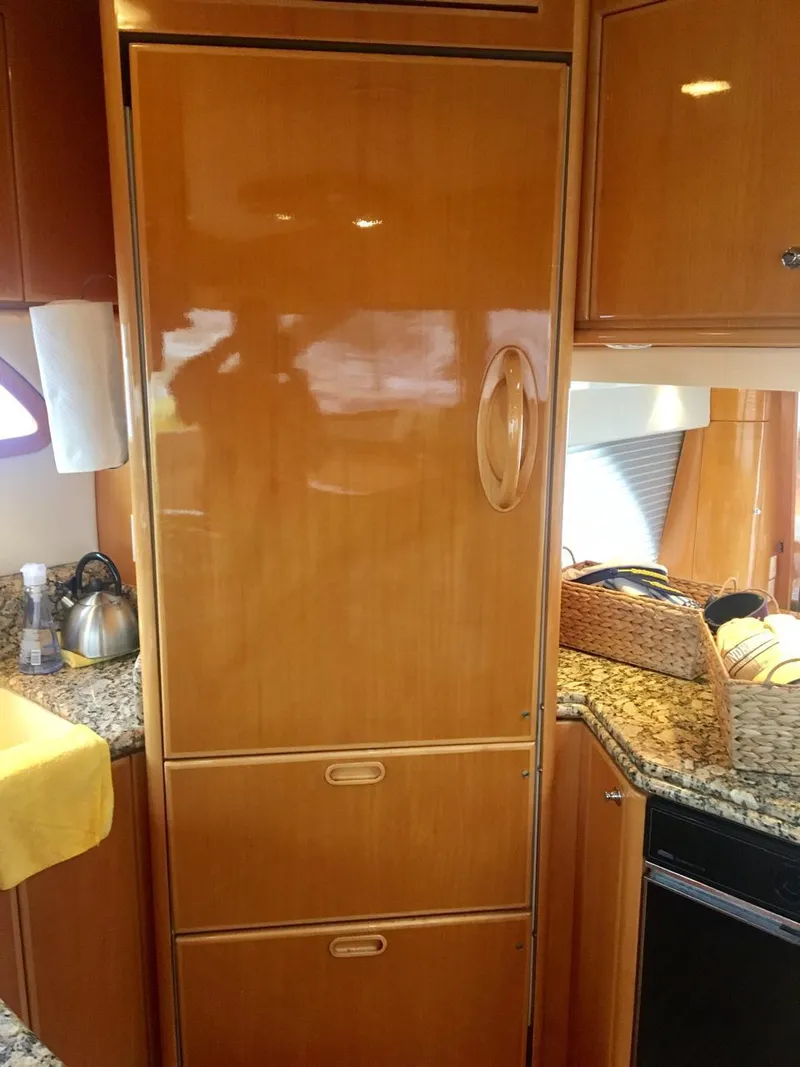 Slide: The Image of 2004 McKinna 58 yacht kitchen with wooden cabinetry and granite countertops. - 5