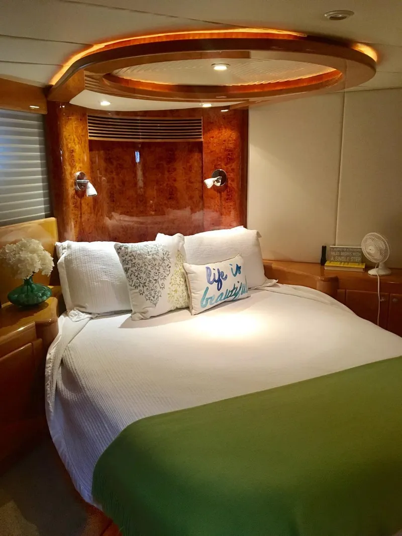 Slide: The Image of Luxurious bedroom interior of a 2004 McKinna 58 yacht with elegant wood accents. - 7