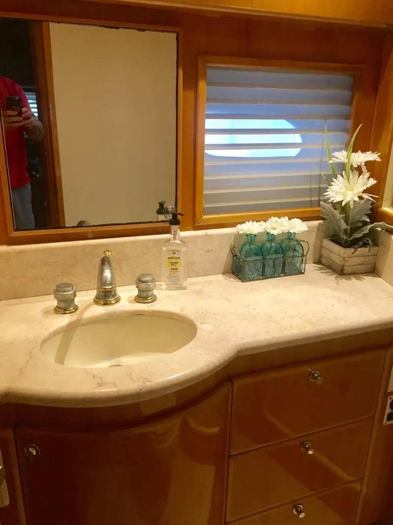 Slide: The Image of Luxurious bathroom in a 2004 McKinna 58 yacht with marble countertop and elegant decor. - 9