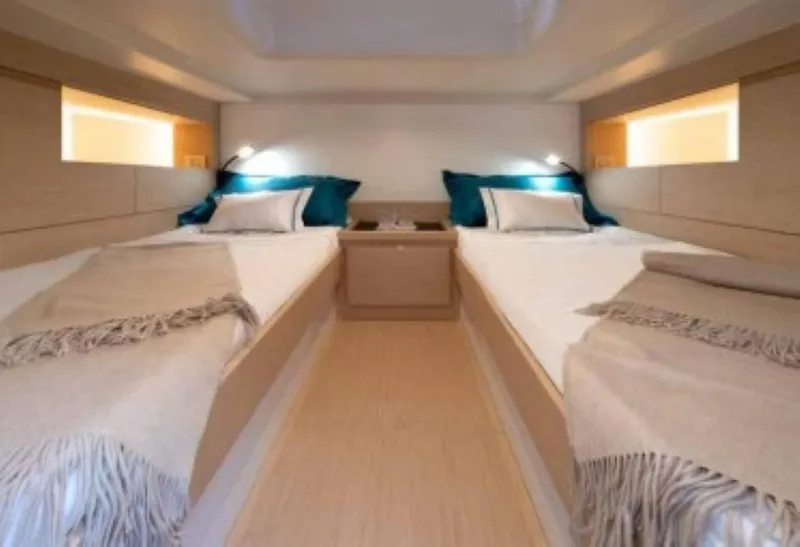 Slide: The Image of 2024 Solaris Power 40 Open cabin with twin beds and modern decor. - 4