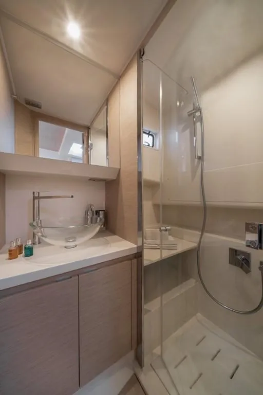 Slide: The Image of Modern bathroom in 2024 Solaris Power 40 Open yacht with glass shower and vessel sink. - 5
