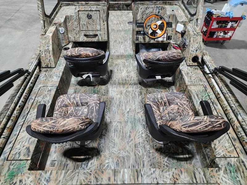 Slide: The Image of 2024 SeaArk EasyCat boat interior with camo seats and steering console. - 5