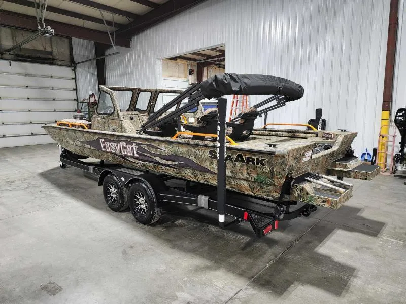 Slide: The Image of 2024 SeaArk EasyCat boat in a warehouse, camo design, on a black trailer. - 8