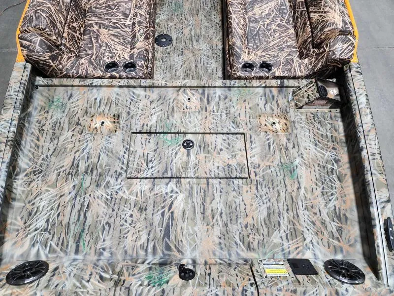 Slide: The Image of 2024 SeaArk EasyCat boat interior with camo pattern and seating. - 9