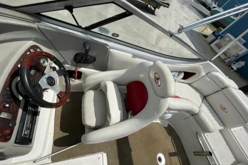 Slide: The Image of 2005 Chaparral 2300 boat interior with steering wheel and seating. - 10