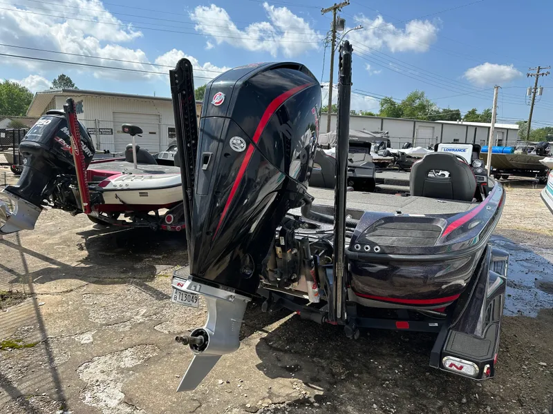 Slide: The Image of 2022 Nitro Z20 Pro bass boat with powerful outboard motor, parked outdoors. - 21