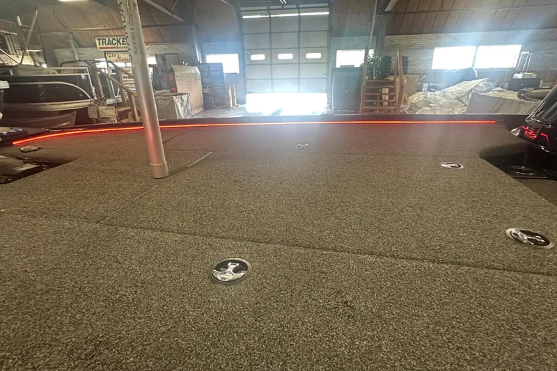 Slide: The Image of Carpeted deck of a 2022 Nitro Z20 Pro boat in a workshop setting. - 26