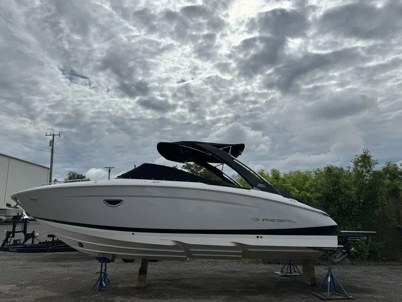 Slide: The Image of 2024 Regal LS9 boat on stands under cloudy sky. - 0