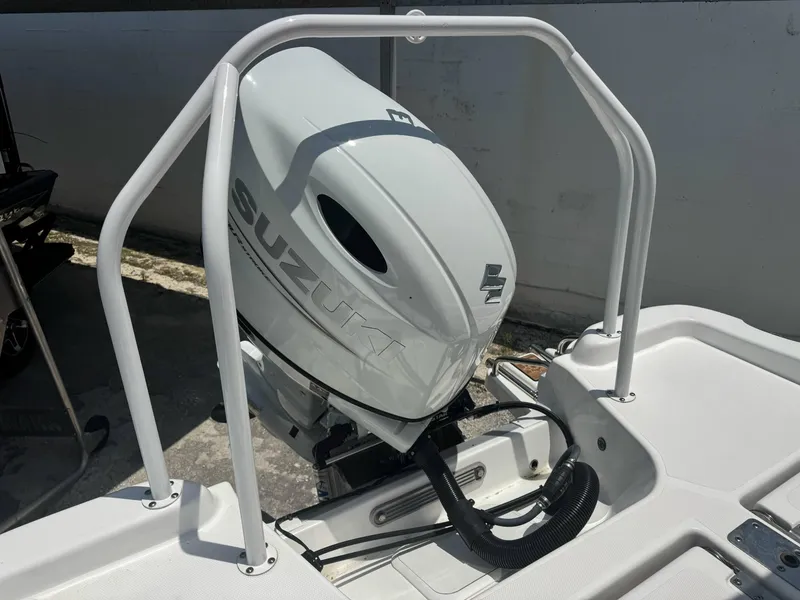 Slide: The Image of 2024 NauticStar 211 Hybrid boat with Suzuki outboard motor, rear view. - 10