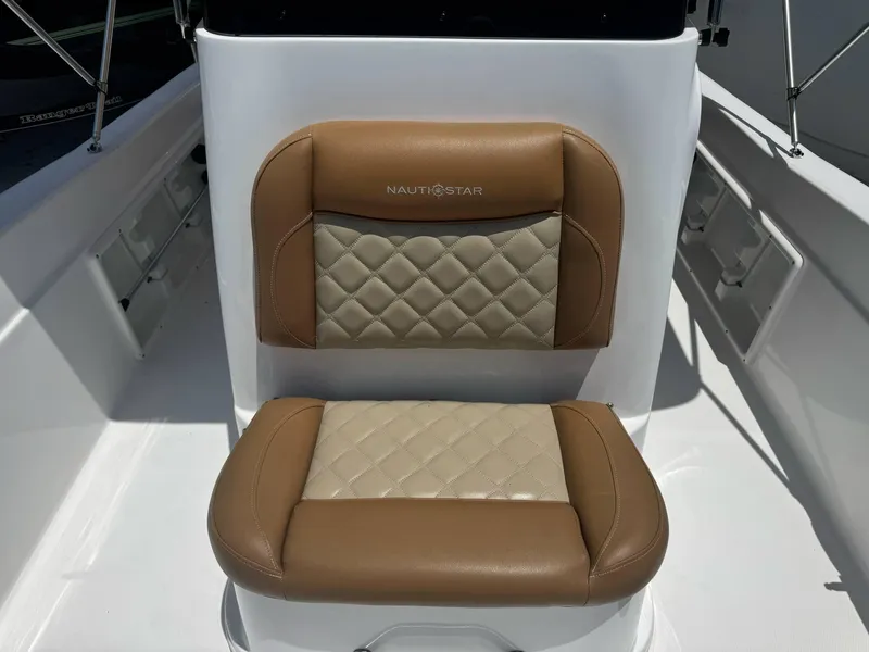 Slide: The Image of 2024 NauticStar 211 Hybrid boat seat with tan and beige quilted upholstery. - 5