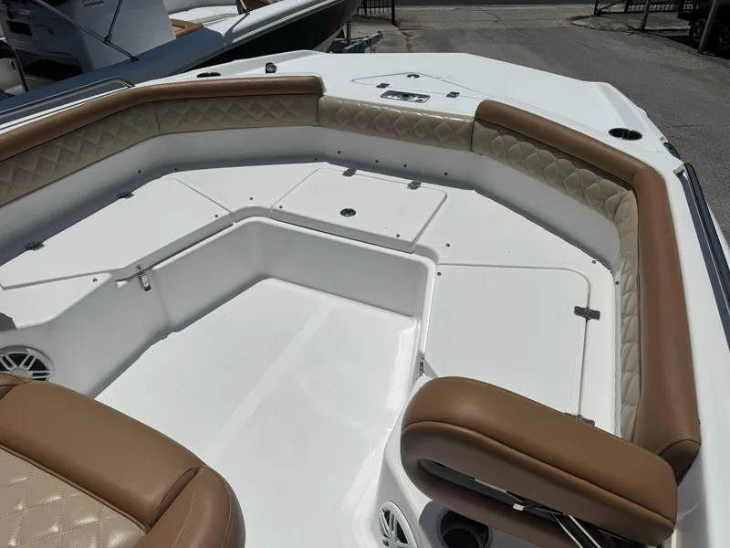 Slide: The Image of 2024 NauticStar 211 Hybrid boat interior with tan seating and white deck. - 6