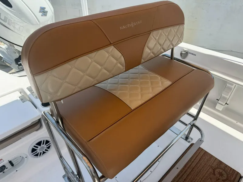 Slide: The Image of 2024 NauticStar 211 Hybrid boat seat with brown and beige quilted upholstery. - 8