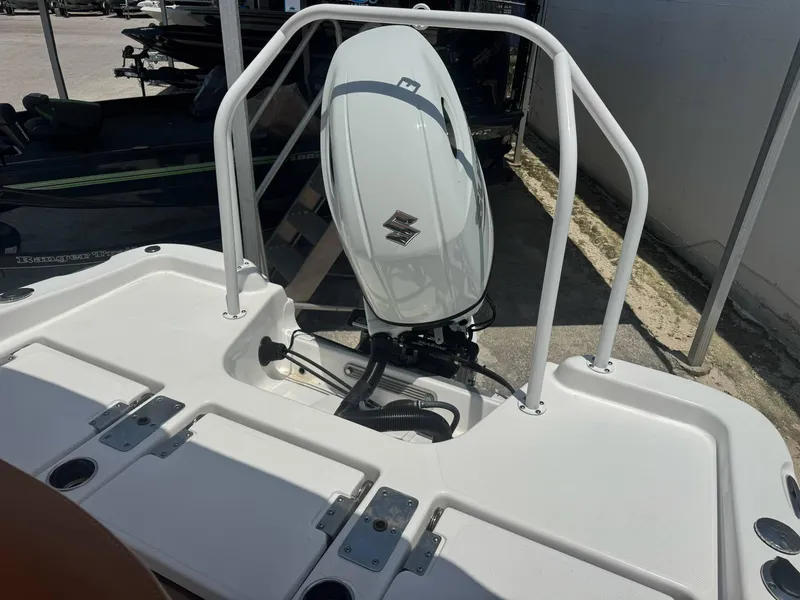 Slide: The Image of 2024 NauticStar 211 Hybrid boat with outboard motor, rear view. - 9