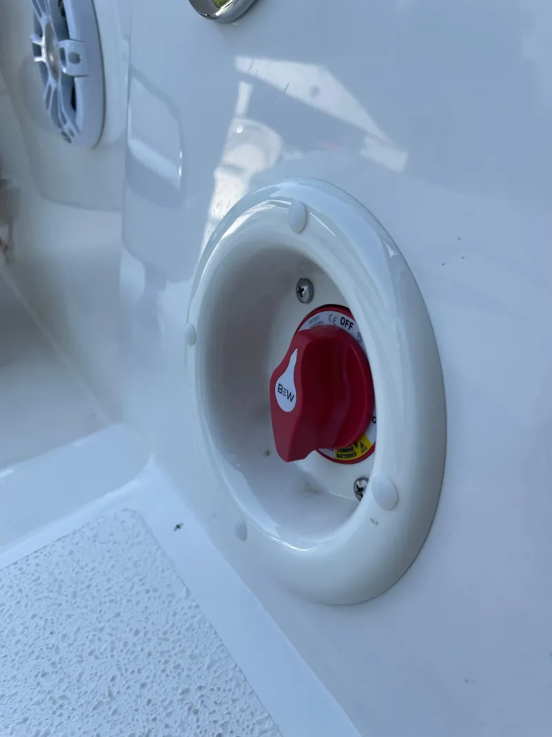 Slide: The Image of Close-up of 2024 Stingray 212 SC boat battery switch. - 6