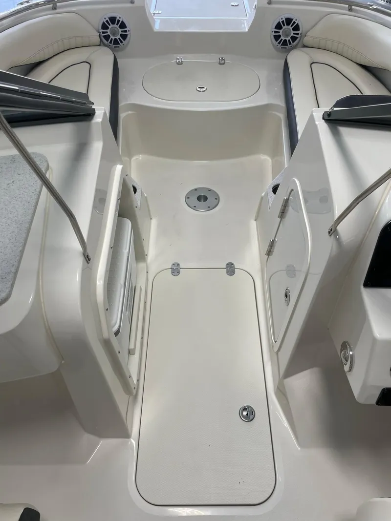 Slide: The Image of 2024 Stingray 201 DC boat interior with seating and storage compartments. - 11