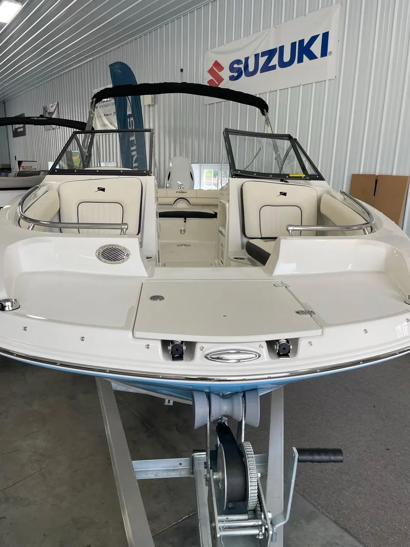 Slide: The Image of 2024 Stingray 201 DC boat on display in showroom. - 3