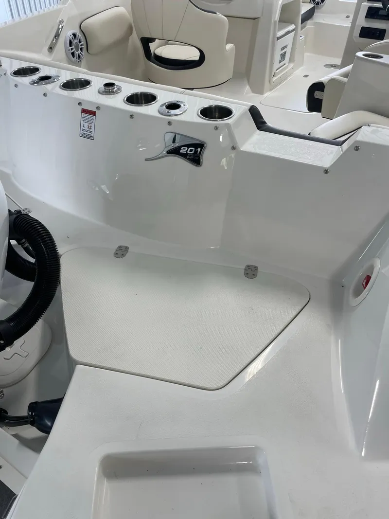 Slide: The Image of 2024 Stingray 201 DC boat interior with seating and cup holders. - 6