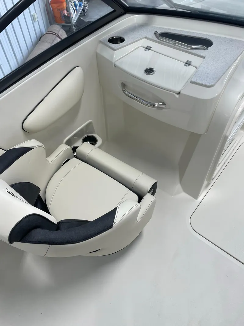 Slide: The Image of 2024 Stingray 201 DC boat interior with captain's chair and console. - 9
