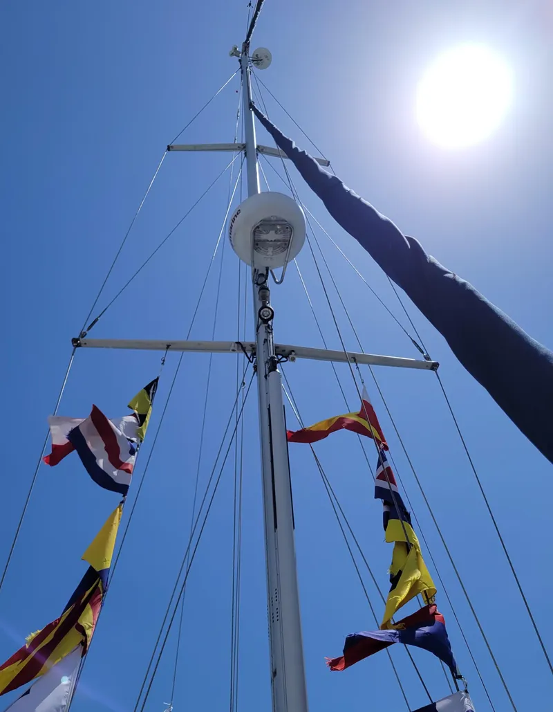 Slide: The Image of Sailboat mast with colorful flags against a bright blue sky, Caliber 40 LRC SE, 2005. - 18