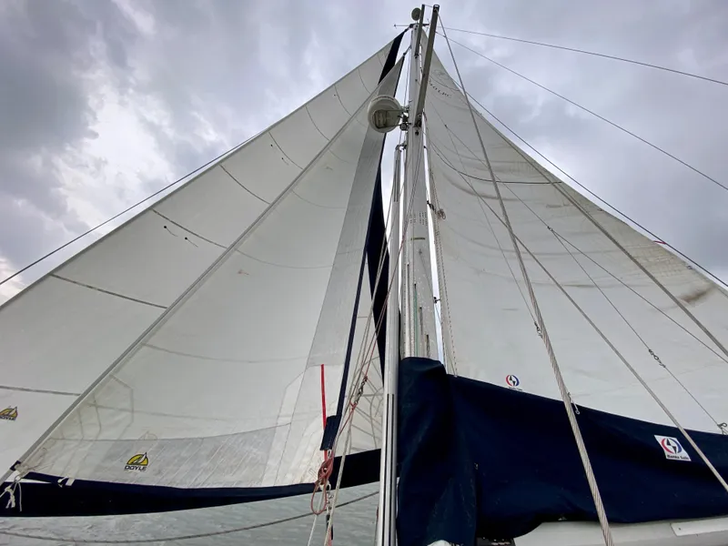 Slide: The Image of Sails of a 2005 Caliber 40 LRC SE yacht against a cloudy sky. - 20