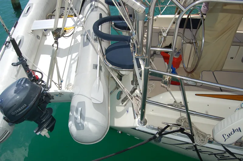 Slide: The Image of 2005 Caliber 40 LRC SE yacht with dinghy and Yamaha outboard motor in marina. - 27